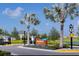 Riverfield community entrance with palm trees and landscaping at 8307 Trimbelle Ter, Parrish, FL 34219