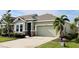 Attractive one-story house with a two-car garage and a neatly landscaped front yard at 8307 Trimbelle Ter, Parrish, FL 34219