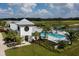 Community pool with clubhouse and surrounding landscape at 8307 Trimbelle Ter, Parrish, FL 34219