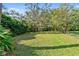 Private backyard oasis with lush landscaping and mature trees at 8628 Woodbriar Dr, Sarasota, FL 34238