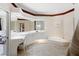 Bathroom with double vanity, garden tub and lots of light at 8628 Woodbriar Dr, Sarasota, FL 34238