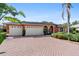 Brick driveway and three-car garage at 8628 Woodbriar Dr, Sarasota, FL 34238