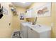 Convenient laundry room with washer, dryer, and utility sink at 8628 Woodbriar Dr, Sarasota, FL 34238