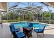 Relaxing screened-in pool area with patio furniture at 8628 Woodbriar Dr, Sarasota, FL 34238