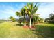 Spacious backyard with lush lawn and palm trees at 8752 Monterey Bay Loop, Bradenton, FL 34212