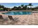 Inviting community pool with lounge chairs and surrounding landscaping at 8752 Monterey Bay Loop, Bradenton, FL 34212