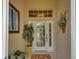 Inviting entryway with a glass door, potted plants, and wall decor at 8752 Monterey Bay Loop, Bradenton, FL 34212