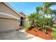 Home's front entrance, featuring a screened door and landscaping at 8752 Monterey Bay Loop, Bradenton, FL 34212