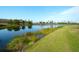 Serene lake view with lush greenery and palm trees at 8752 Monterey Bay Loop, Bradenton, FL 34212