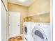 Laundry room with washer, dryer, and ample shelving at 8752 Monterey Bay Loop, Bradenton, FL 34212