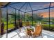 Relaxing screened porch with fire pit and comfortable seating at 8752 Monterey Bay Loop, Bradenton, FL 34212