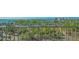 Balcony view showcasing lush landscaping, water, and cityscape at 101 S Gulfstream Ave # 8G, Sarasota, FL 34236