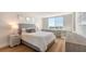 Bright bedroom with light grey walls and hardwood floors. Features a built-in desk and water views at 101 S Gulfstream Ave # 8G, Sarasota, FL 34236