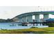 Bridge over calm water with boat and pier at 101 S Gulfstream Ave # 8G, Sarasota, FL 34236