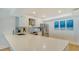 Modern white kitchen with stainless steel appliances and quartz countertops at 101 S Gulfstream Ave # 8G, Sarasota, FL 34236