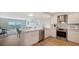 Open concept kitchen with white cabinets, stainless steel appliances, and a breakfast bar at 101 S Gulfstream Ave # 8G, Sarasota, FL 34236