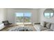 Bright living room with water views and sliding glass door to balcony at 101 S Gulfstream Ave # 8G, Sarasota, FL 34236