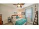 Cozy bedroom with a wicker headboard, teal bedding, and coastal decor at 10515 52Nd E Ct, Parrish, FL 34219