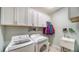 Laundry room with white cabinets, washer, dryer, and utility sink at 10515 52Nd E Ct, Parrish, FL 34219