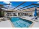 Resort-style pool with a covered patio and fire features at 10619 Restoration Ter, Bradenton, FL 34212