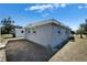 Gray house exterior with windows, detached shed, and yard at 1108 26Th Street E Ct, Palmetto, FL 34221