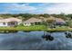 Aerial view of waterfront homes with lush landscaping at 115 Grand Oak Cir, Venice, FL 34292