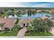 Aerial view of a waterfront home and neighborhood at 115 Grand Oak Cir, Venice, FL 34292
