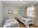 Twin bedroom with light walls, ceiling fan, and wood floors at 115 Grand Oak Cir, Venice, FL 34292