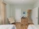 Guest bedroom with twin beds, wicker dresser, and sitting chair at 115 Grand Oak Cir, Venice, FL 34292