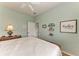 Bright guest bedroom with wood flooring and door to hallway at 115 Grand Oak Cir, Venice, FL 34292