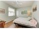 Bedroom with light walls, ceiling fan and wood floors at 115 Grand Oak Cir, Venice, FL 34292