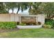 Elegant Hidden Lakes Club entrance with landscaped landscaping and signage at 115 Grand Oak Cir, Venice, FL 34292