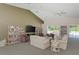 Relaxing community room with comfortable seating, bookshelves, and a large TV at 115 Grand Oak Cir, Venice, FL 34292