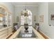 Formal dining room featuring a glass-top table and chandelier, hardwood floors at 115 Grand Oak Cir, Venice, FL 34292
