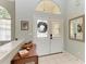 Bright and airy entryway with double doors and a decorative wreath at 115 Grand Oak Cir, Venice, FL 34292