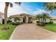 House exterior featuring a welcoming entryway and meticulously maintained landscaping at 115 Grand Oak Cir, Venice, FL 34292