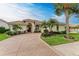 Elegant home exterior with a large driveway and lush landscaping at 115 Grand Oak Cir, Venice, FL 34292