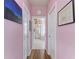 Hallway with light pink walls and access to the main bathroom at 115 Grand Oak Cir, Venice, FL 34292