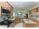 Spacious kitchen featuring granite countertops, stainless steel appliances, and ample cabinetry at 115 Grand Oak Cir, Venice, FL 34292