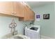 Convenient laundry room with washer, dryer, and cabinets at 115 Grand Oak Cir, Venice, FL 34292