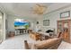 Relaxing living area with hardwood floors, a comfy sofa, and views to the backyard at 115 Grand Oak Cir, Venice, FL 34292