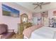 Spacious main bedroom with a king bed, dresser, and views to the backyard at 115 Grand Oak Cir, Venice, FL 34292