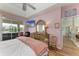 Main bedroom with a king bed, dresser, and views of the pool and canal at 115 Grand Oak Cir, Venice, FL 34292