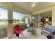 Spacious screened lanai with lake views and access to the interior at 115 Grand Oak Cir, Venice, FL 34292