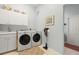 Bright laundry room with washer, dryer, and cabinets at 11509 28Th Street E Cir, Parrish, FL 34219