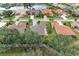 Aerial view of houses and a neighborhood with a lake at 120 Grand Oak Cir, Venice, FL 34292