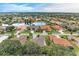 Community overview showcasing a serene lake and numerous homes at 120 Grand Oak Cir, Venice, FL 34292