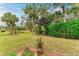 Lush green backyard with mature trees and landscaping at 120 Grand Oak Cir, Venice, FL 34292