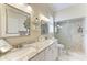 Double vanity bathroom with granite countertop and large shower at 120 Grand Oak Cir, Venice, FL 34292