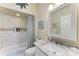 Bathroom with shower/tub combo, granite vanity, and a window at 120 Grand Oak Cir, Venice, FL 34292